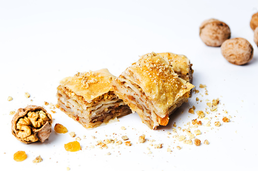 Baklava dessert slices with nuts on white background