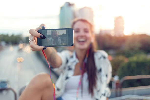 istock Laughing woman making selfies with her phone 954947606