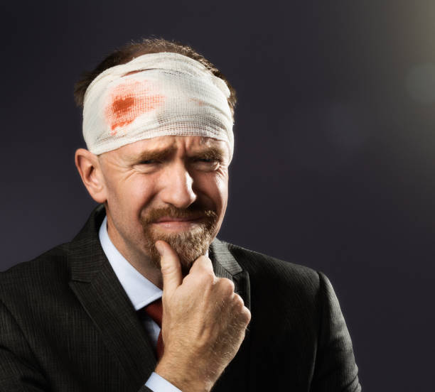 istock Battered bandaged businessman looks worried 954948808