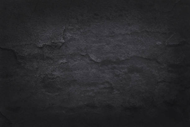 Dark grey black slate texture in natural pattern with high resolution for background and design art work. Black stone wall.