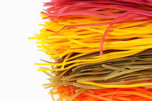 Raw colored spaghetti on white clean background