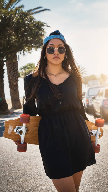 istock Lovely young woman with her skateboard at the seaside 954952182