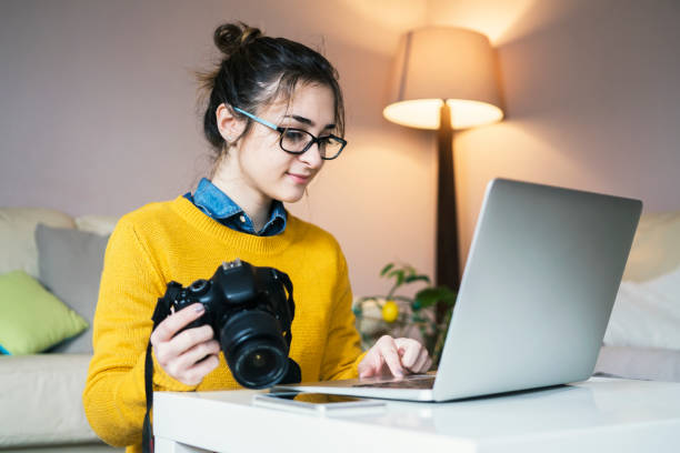 istock Young female photographer working at home 954956622