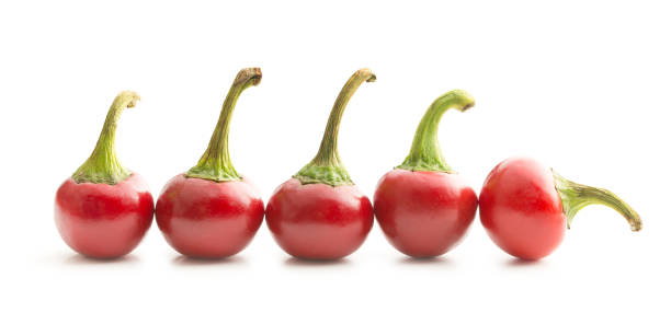 istock Round chili peppers isolated on white background. 954957038