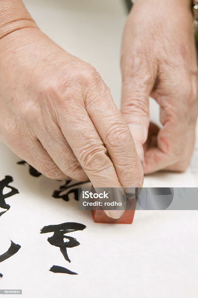 Hand holding agalmatolite stamp  Chinese Stamp Stock Photo
