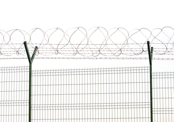 istock barbed wire and fence for security at airport 954966002