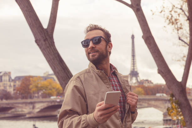 istock Smiling man using cellphone in the European city. 954966240