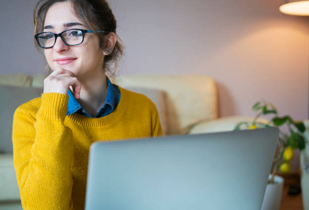 istock Young woman at home chatting with friends 954967352