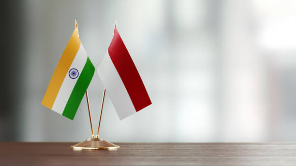 istock Indian And Indonesian Flag Pair On A Desk Over Defocused Background 954970276