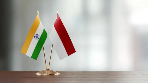 Photo of Indian And Indonesian Flag Pair On A Desk Over Defocused Background
