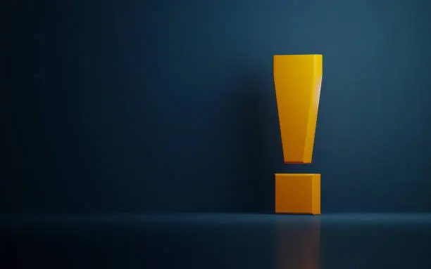 Photo of Yellow Exclamation Point On Dark Blue Background