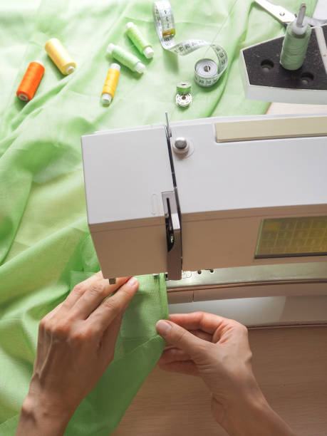 istock Sewing process close-up on the sewing machine. Industrial sewing machine in a private workshop at work. 954976230