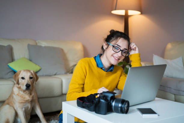 istock Young female photographer working at home 954978660