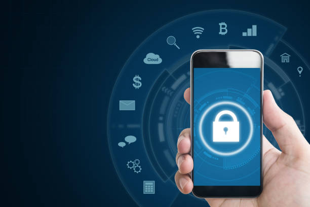 istock Mobile device security system. Hand holding mobile smart phone with lock and application icons. on blue background 954979398