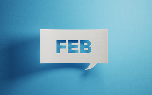White chat bubble on  blue background. February writes on chat bubble. Horizontal composition with copy space.