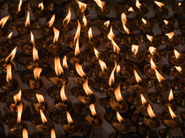 istock Large group of burning candles against dark background 954983742
