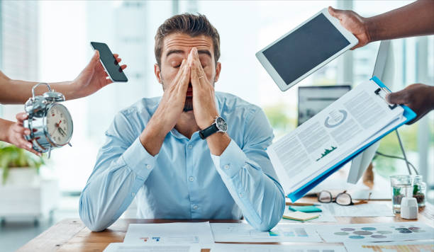 So many demands and deadlines are closing in on him Portrait of a young businessman looking stressed out in a demanding office environment emotional stress stock pictures, royalty-free photos & images