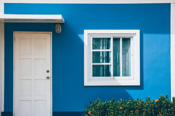 Front of resort with door and window on green background Front of resort with door and window on blue backgroundFront of resort with door and window on green background facade stock pictures, royalty-free photos & images