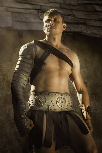 istock handsome muscular man gladiator in armour. concept of masculinity, determination, strength 954987514