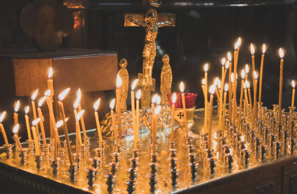 istock Many candles glowing on table in orthodox church. 955007848