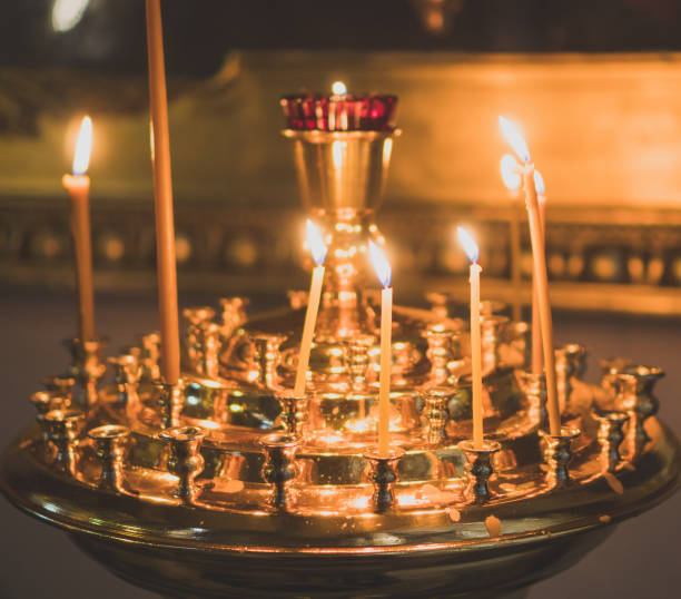 istock Metal candle light cresset in church. 955007894