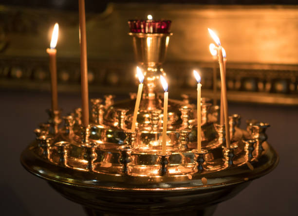 istock Metal candle light cresset in church. 955007896