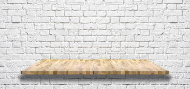 istock white brick wall with Wooden light shelf 955010102
