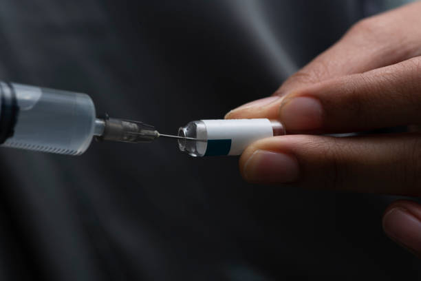 istock Drawing medicine from a glass vial 955014180