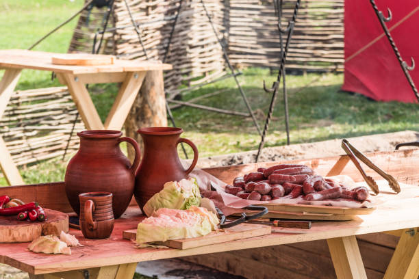 istock Table for cooking outdoors on a picnic - glazed jugs, vegetables and cooking products on the table 955015276