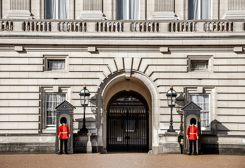 London, UK - April 26, 2018: The royal guards at Buckingham Palace, residence and principal workplace of the monarchy of the United Kingdom.
