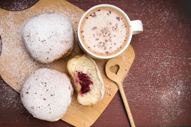 istock Classic donuts with powdered sugar, on wooden background 955023922