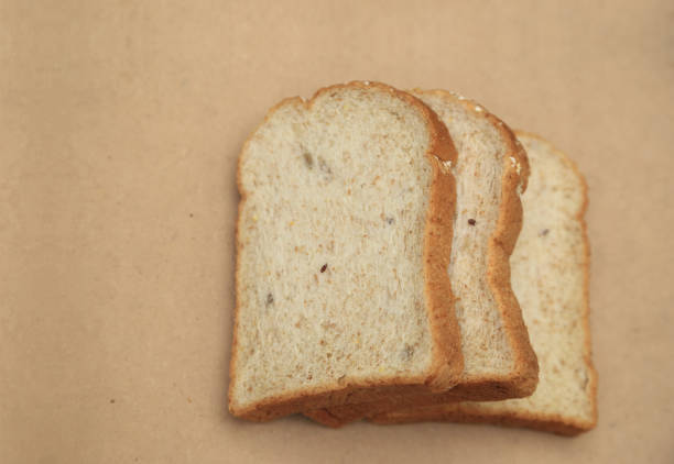 istock Whole grain bread on natural brown texture background with space for text. 955025560