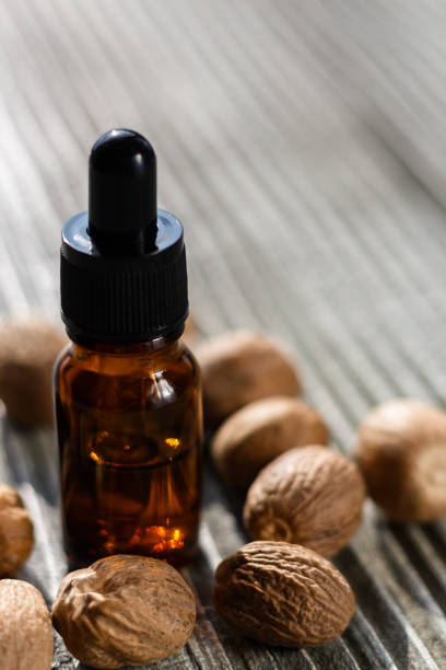 istock nutmeg essential oil on a gray wooden background 955028218