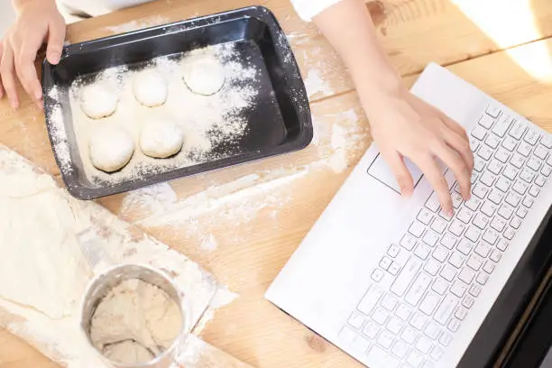Process of cooking buns. Raw dough. White flour. Bright laptop/