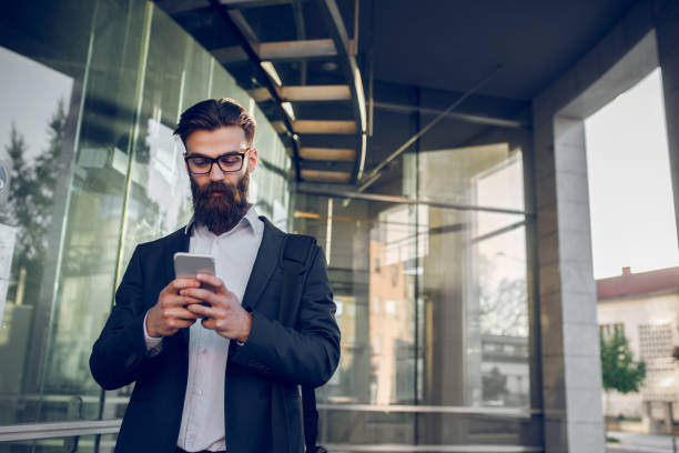 istock Young businessman typing text message on mobile phone 955031394