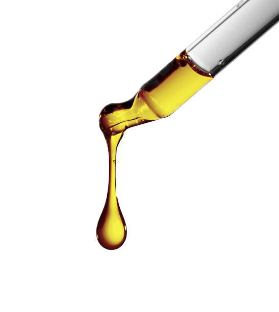 istock Petroleum oil dropping from glass dropper 955032002
