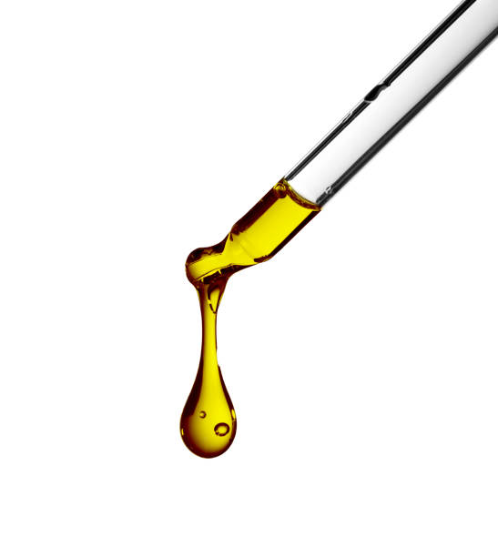 istock Petroleum oil dropping from glass dropper 955032008
