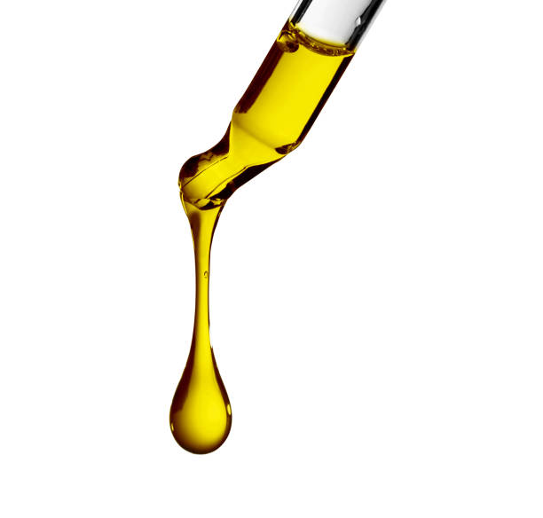 istock Petroleum oil dropping from glass dropper 955032010