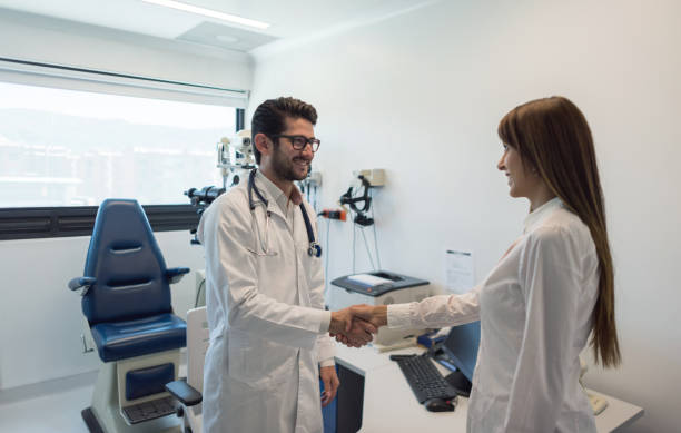 istock Friendly optometrist greeting a female patient arriving for consult 955034096