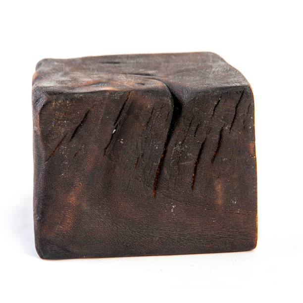 istock Big old dark cube is cut out from old wood. Isolated on white 955037248