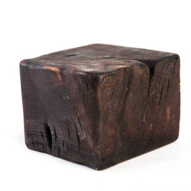 istock Big old dark cube is cut out from old wood. Isolated on white 955037312