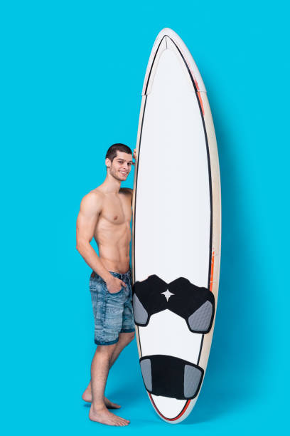 istock Attractive surfer holding a surfboard 955037500