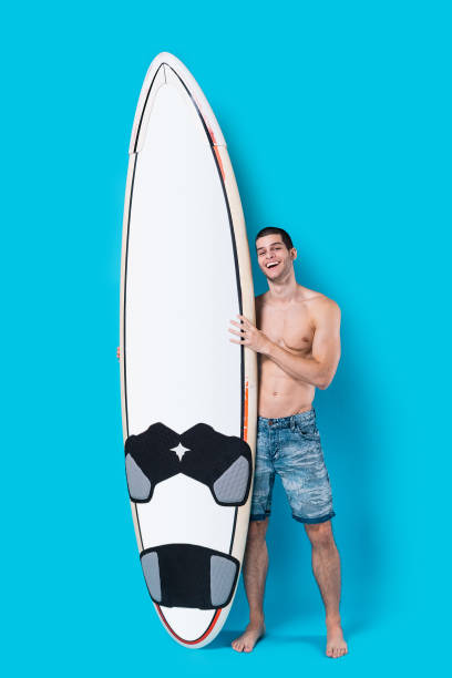 istock Attractive surfer holding a surfboard 955037518