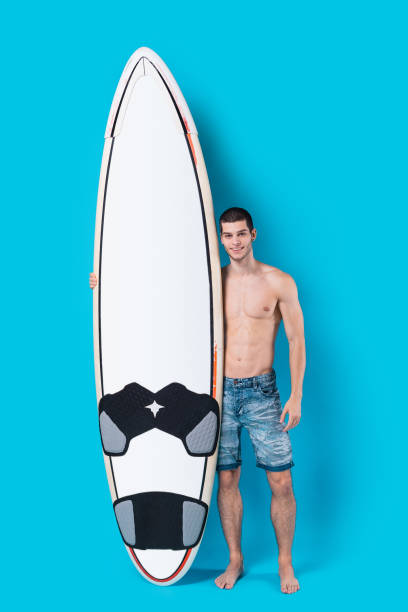 istock Attractive surfer holding a surfboard 955037544