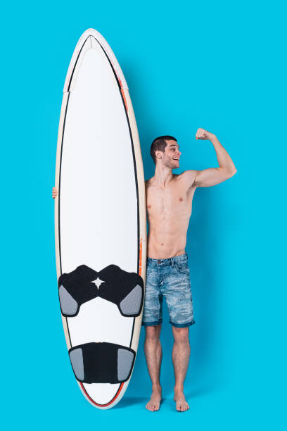 istock Attractive surfer holding a surfboard 955037552