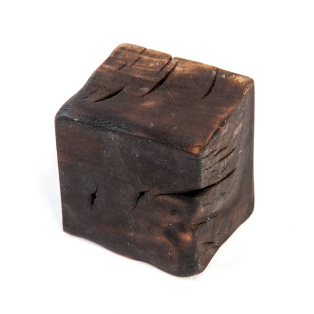 istock Big old dark cube is cut out from old wood. Isolated on white 955037738