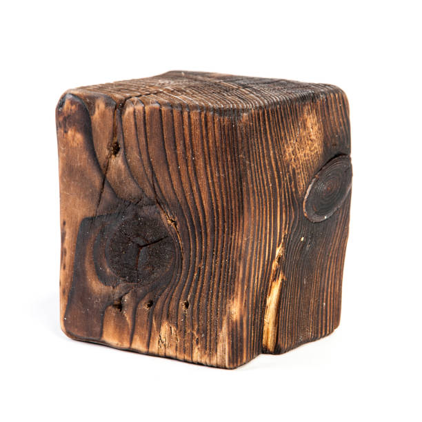 istock Big old dark cube is cut out from old wood. Isolated on white 955040200