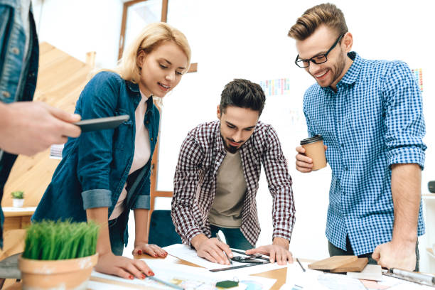 istock Team of designers architects discuss project. 955044528