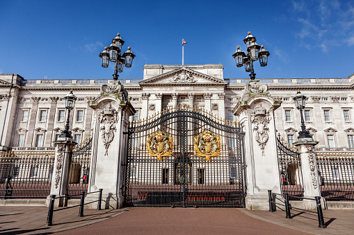 London, England- 1983: A vintage 1980's Nikon negative film scan of a building exterior photography inside the gates of Buckingham Palace in London, England in the morning.