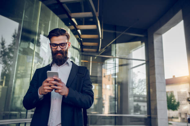 istock Young businessman typing text message on mobile phone 955044584